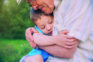 Happy grandson hugging his grandfather