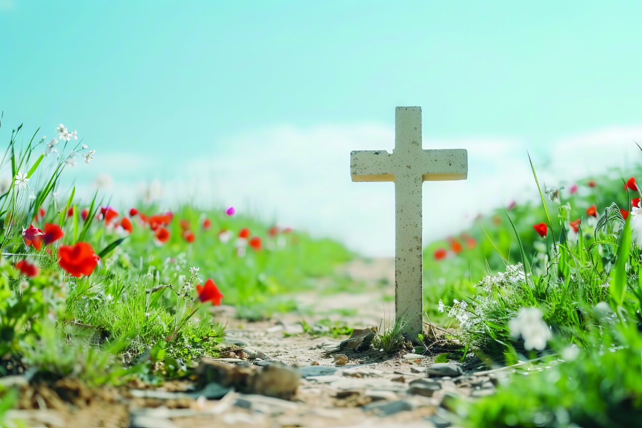 Memorial Day with a battlefield cross against a clear blue sky.