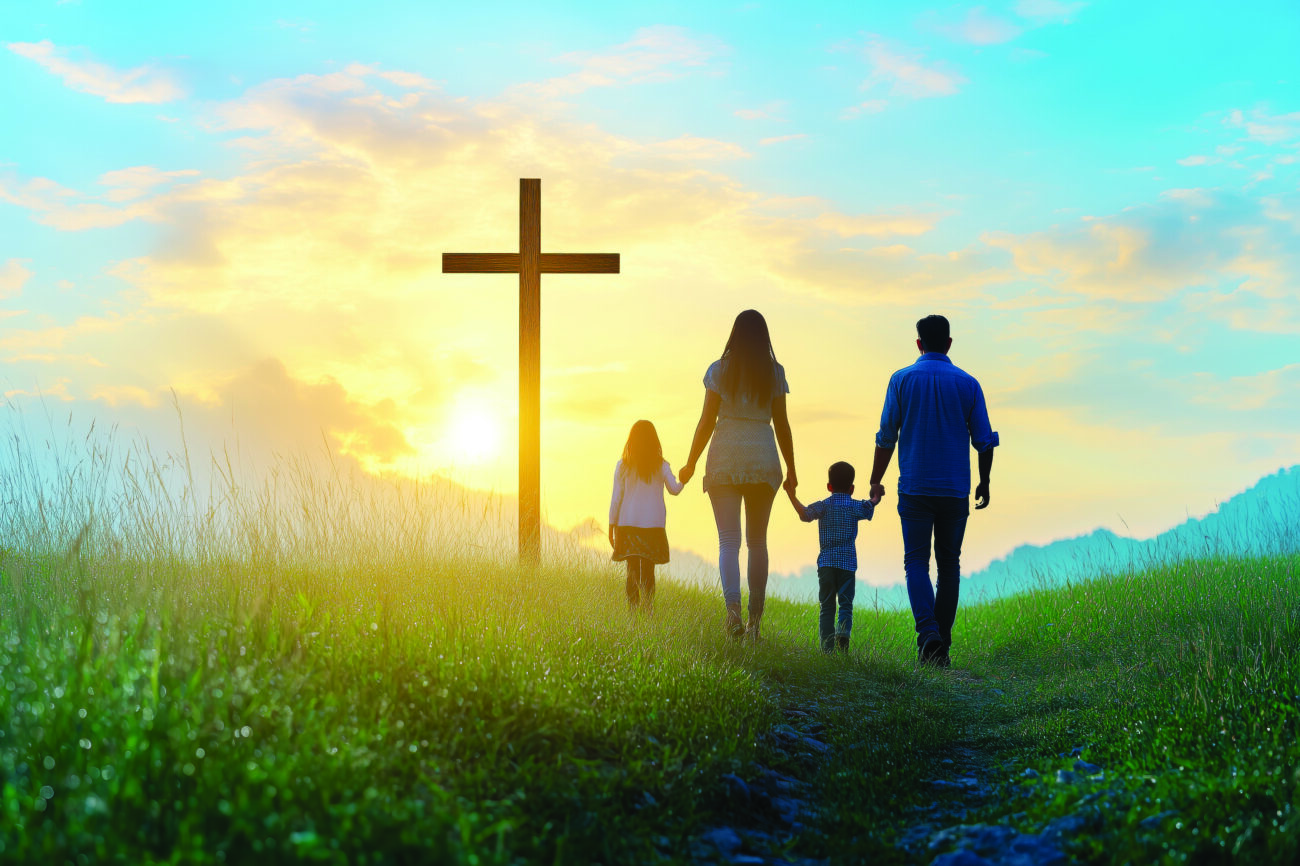 Silhouette of Family Walking to Christian Cross at Sunset