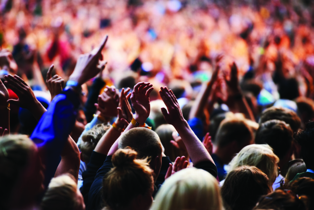 Shot of a crowd of young people at an outdoor music festival.